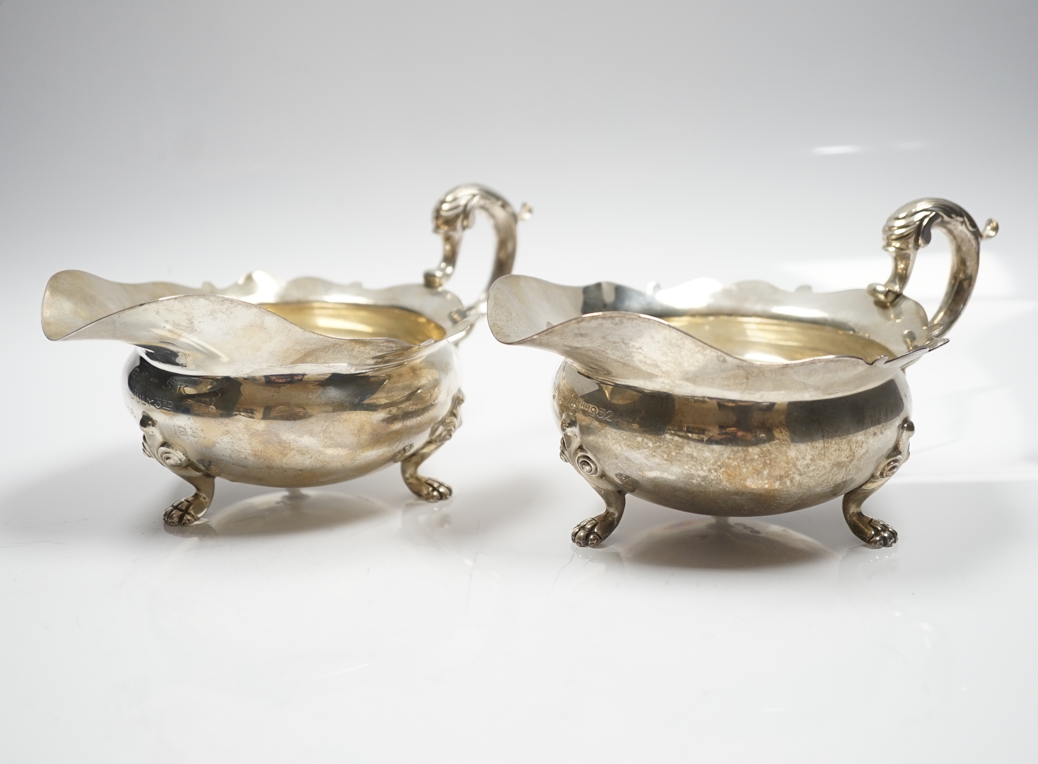A pair of George V silver sauce boats, by Goldsmiths & Silversmiths Co Ltd, London, 1927 and 1932, length 18.2cm, 15.3oz.